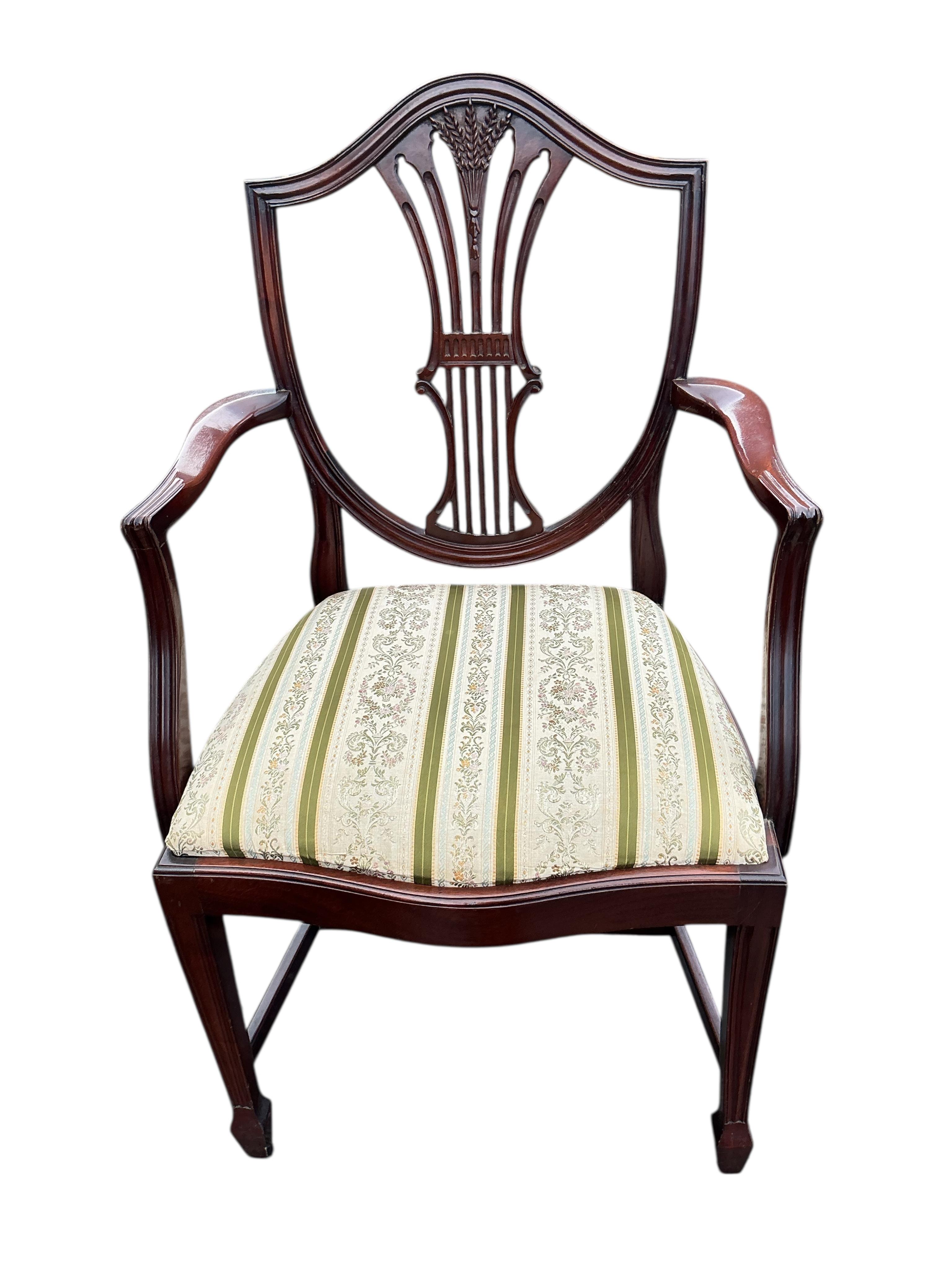 A set of ten reproduction Hepplewhite style mahogany dining chairs, two with arms